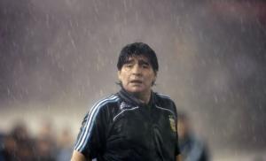 Diego Maradona stands in rain during their World Cup 2010 qualifying soccer match